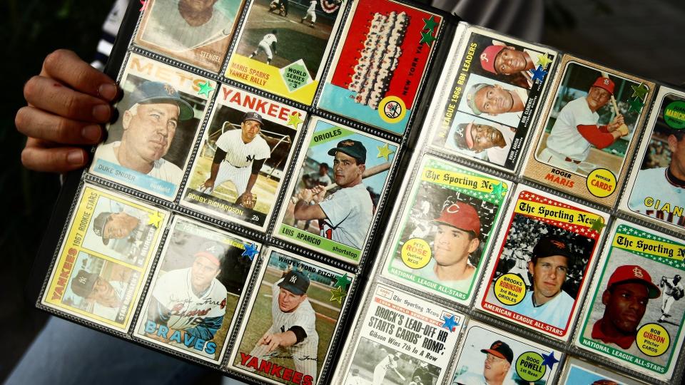 NEW YORK - SEPTEMBER 21:  A man sells vintage baseball cards prior to the start of the last game at Yankee Stadium between the Baltimore Orioles and the New York Yankees on September 21, 2008 at Yankee Stadium in the Bronx borough of New York City.