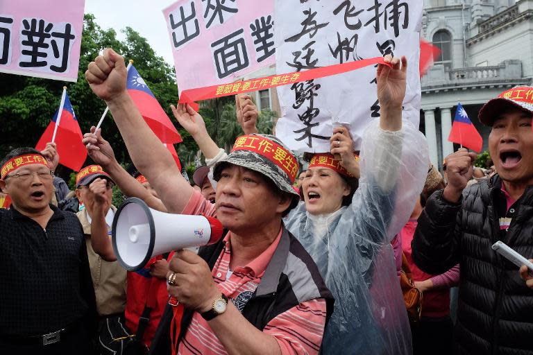 Taiwanese activists chant slogans as they demonstrate in support of a controversial trade pact with China during a mass rally in Taipei, on April 1, 2014