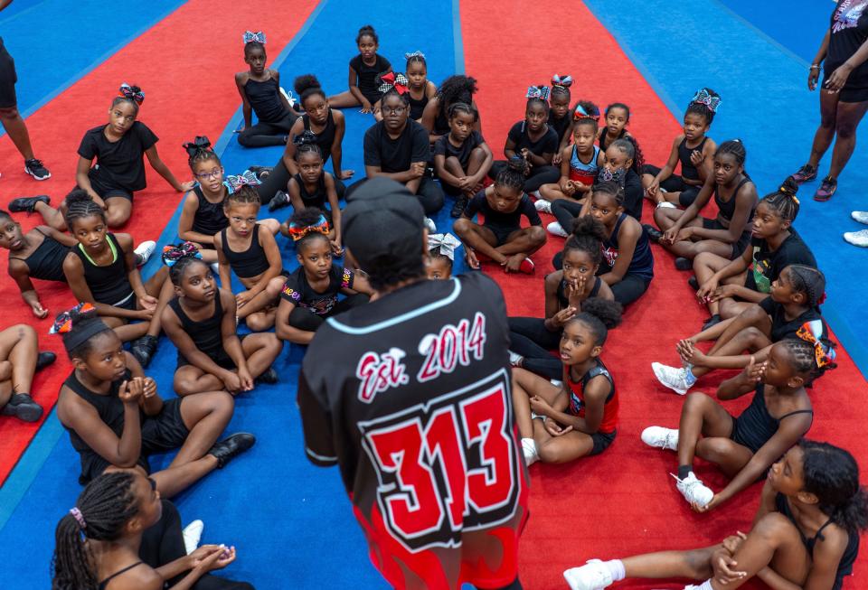 Detroit PAL cheer commissioner Glenda "Coach Pott" Stancil talks with members of the Motor City Heat Elite cheer team during a practice at St. Paul Tabernacle Church of God in Christ in Detroit on Aug. 22, 2023.