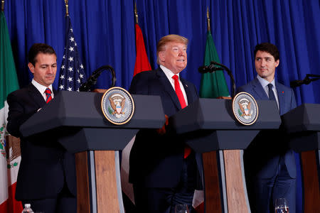 U.S. President Donald Trump, Canada's Prime Minister Justin Trudeau and Mexico's President Enrique Pena Nieto attend the USMCA signing ceremony before the G20 leaders summit in Buenos Aires, Argentina November 30, 2018. REUTERS/Kevin Lamarque