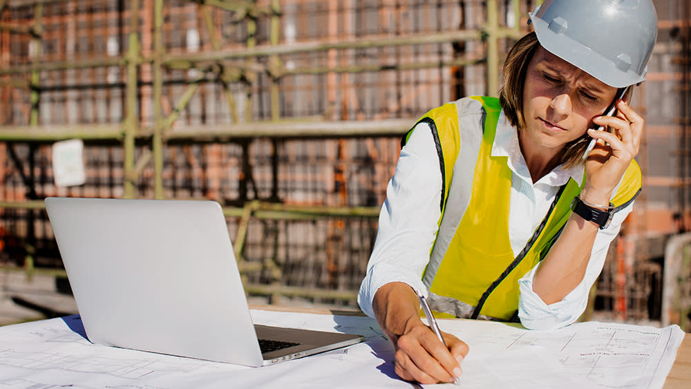  An architect using one of the best laptops for architects at a construction site 