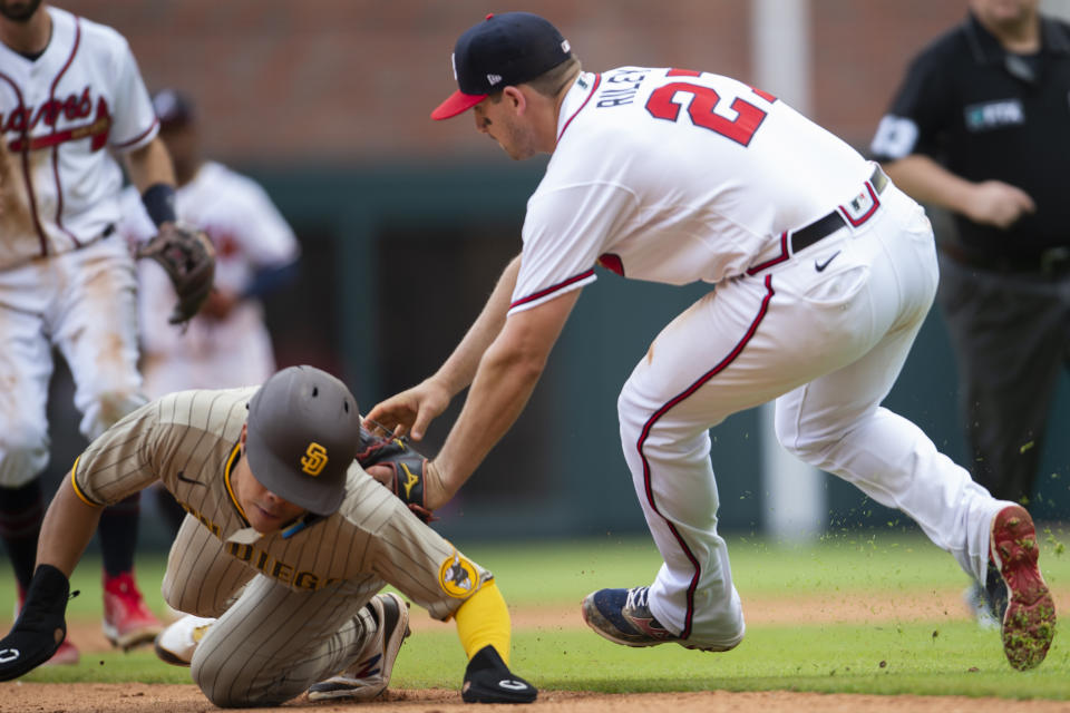 Atlanta Braves third baseman Austin Riley (27) tags San Diego Padres' Ha-Seong Kim, left, during the eighth inning of a baseball game Sunday, May 15, 2022, in Atlanta. (AP Photo/Hakim Wright Sr)