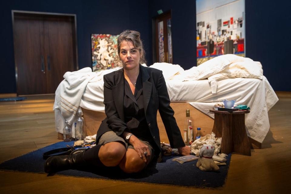 Emin sits in front of her 1998 piece ‘My Bed’ on display at Christie’s in 2014 (Getty Images)