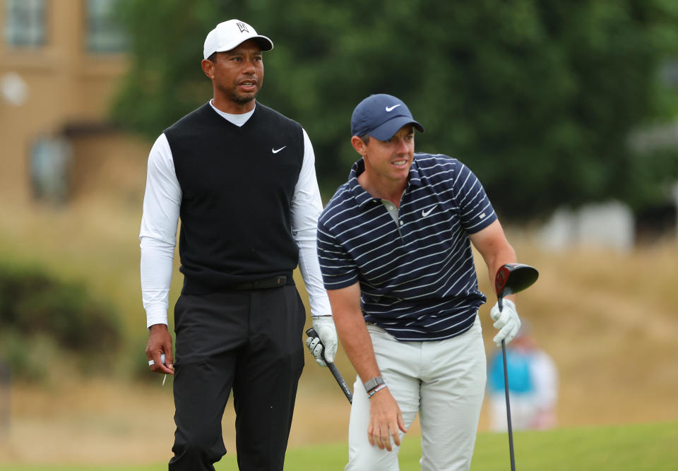 ST ANDREWS, SCOTLAND - JULY 11: Tiger Woods of The United States and Rory McIlroy of Northern Ireland interact on the 18th during the Celebration of Champions Challenge during a practice round prior to The 150th Open at St Andrews Old Course on July 11, 2022 in St Andrews, Scotland. (Photo by Kevin C. Cox/Getty Images)