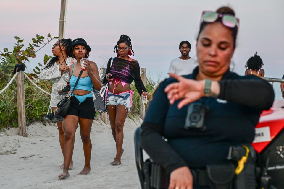 Tourists leave the beach after Miami Beach police closed access on South Beach during this Spring Break weekend on March 8, 2024.