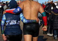 <p>Polar Bear Club swimmers walk out of the Atlantic Ocean after making their annual icy plunge into it on New Year’s Day, January 1, 2018, at Coney Island in the Brooklyn borough of New York City. (Photo: Yana Paskova/Getty Images) </p>