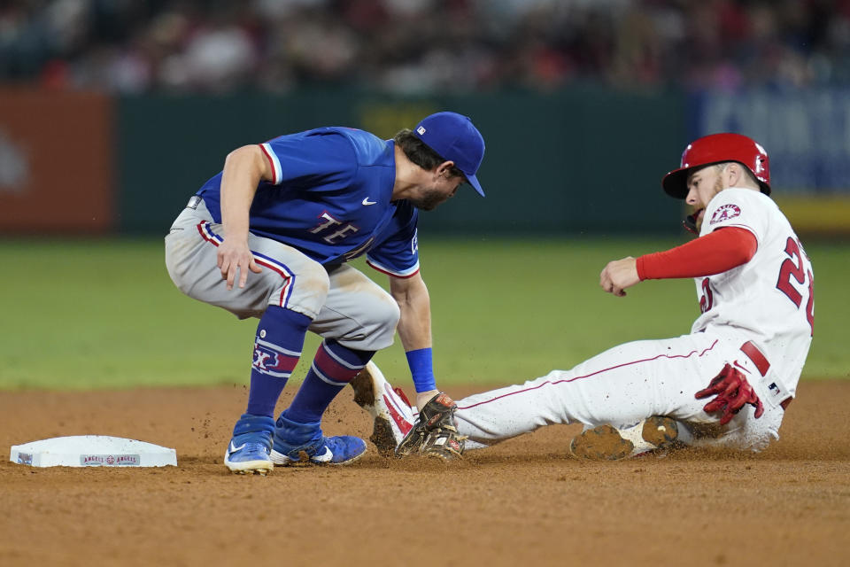 Los Angeles Angels' Jared Walsh, right, is out at second with a tag by Texas Rangers second baseman Nick Solak during the sixth inning of a baseball game Friday, Sep. 3, 2021, in Anaheim, Calif. (AP Photo/Ashley Landis)