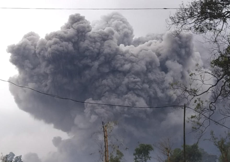 In this photo released by Indonesia's National Disaster Mitigation Agency (BNPB) Mount Semeru spews volcanic material during an eruption in Lumajang, East Java, Indonesia, Saturday, Jan. 16, 2021. The highest volcano on Indonesia's most densely populated island of Java, spewed hot clouds as far away as 4.5 kilometers (nearly 3 miles) on Saturday. (National Disaster Mitigation Agency via AP)