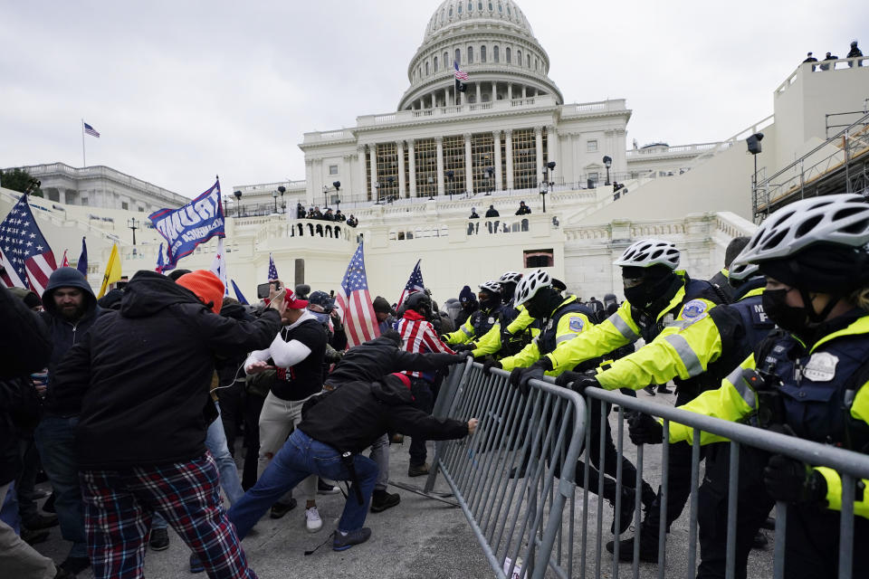 FILE - Violent insurrectionists loyal to President Donald Trump supporters try to break through a police barrier, Wednesday, Jan. 6, 2021, at the Capitol in Washington. (AP Photo/Julio Cortez, File)