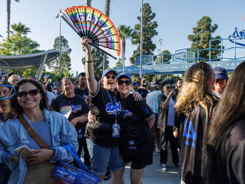 Dodgers fans Denise, left, and Colleen Quinn-Allen enjoy Pride Night at Dodger Stadium.