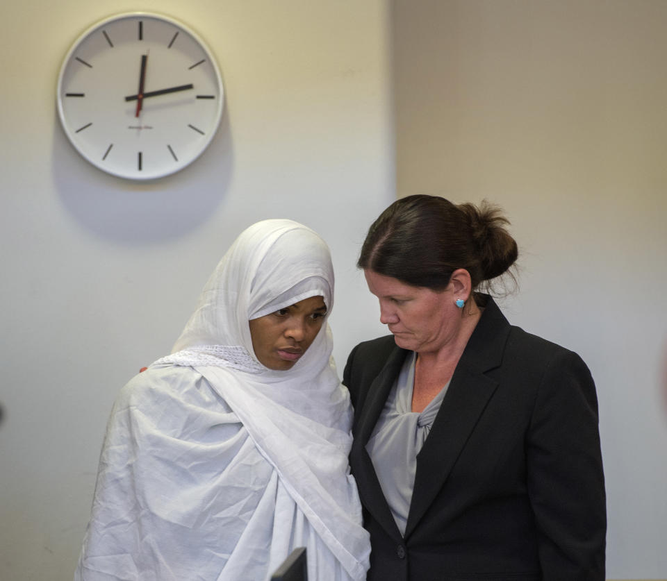 FILE - In this Aug. 29, 2018, file photo, Hujrah Wahhaj, left, talks with her attorney Marie Legrand Miller during a hearing on a motion to dismiss in the Taos County Courthouse in Taos, N.M. Federal prosecutors say the FBI has arrested five former residents, including Hujrah Wahhaj, of a ramshackle compound in northern New Mexico on firearms and conspiracy charges as local prosecutors dropped charges in the death of a 3-year-old boy at the property. Taos County District Attorney Donald Gallegos said Friday, Aug. 31, his office will now seek grand jury indictments involving the death. (Eddie Moore/The Albuquerque Journal via AP, Pool, File)