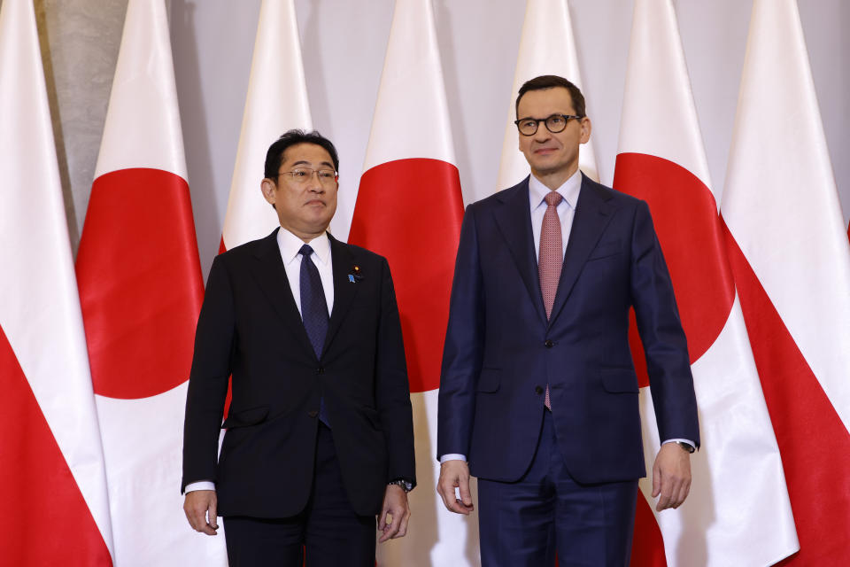 Polish Prime Minister Mateusz Morawiecki, right, welcomes Japanese Prime Minister Fumio Kishida, left, for a meeting in Warsaw, Poland, Wednesday, March 22, 2023. (AP Photo/Michal Dyjuk)