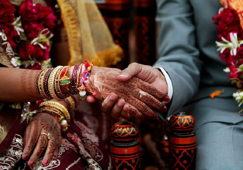 Two couples in India had to undergo a wedding ceremony again after they married the wrong partner due to power failure. — AFP pic