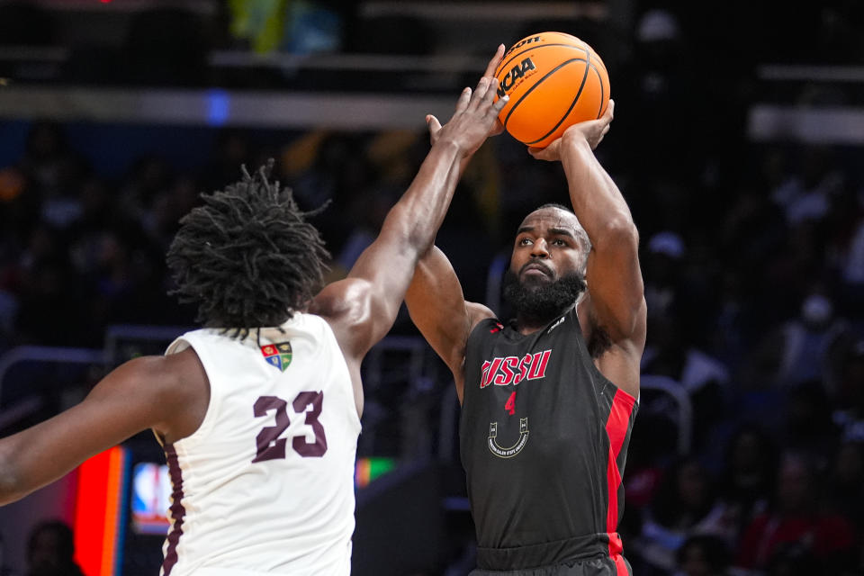 Winston-Salem State guard Jaylen Alston (4) shoots over Virginia Union forward Jonathan Salazar (23) during the second half of the HBCU Classic NCAA college basketball game in Indianapolis, Saturday, Feb. 17, 2024. (AP Photo/Michael Conroy)