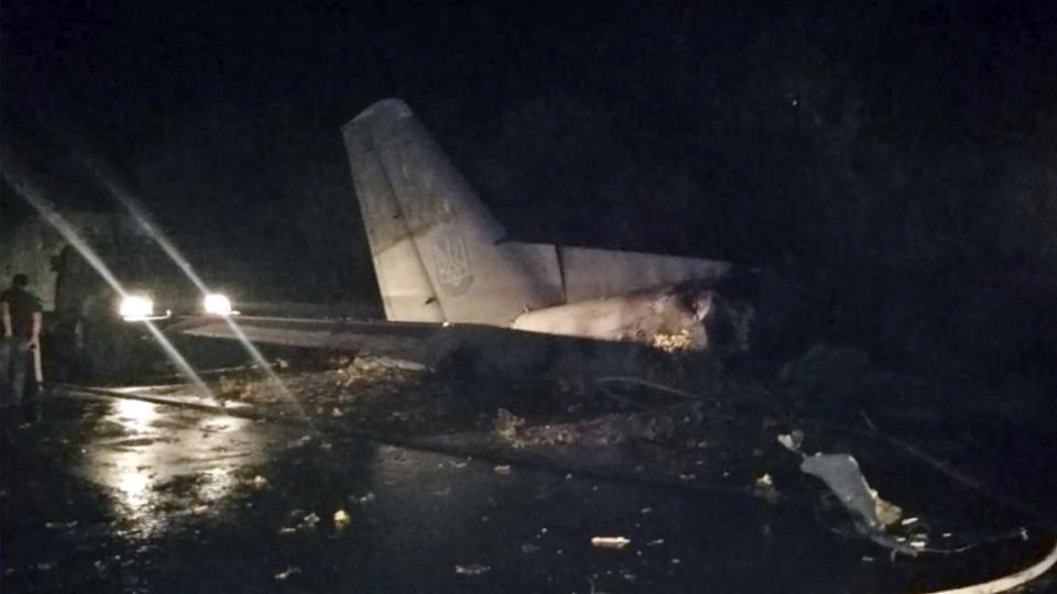 Wreckage from a military place lies on the ground after a fiery crash in the town of Chuguyiv, Ukraine.