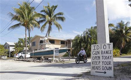 A sign placed by a neighbor is seen at the intersection closest to the home of Doug Varrieur in Big Pine Key in the Florida Keys March 5, 2014. REUTERS/Andrew Innerarity