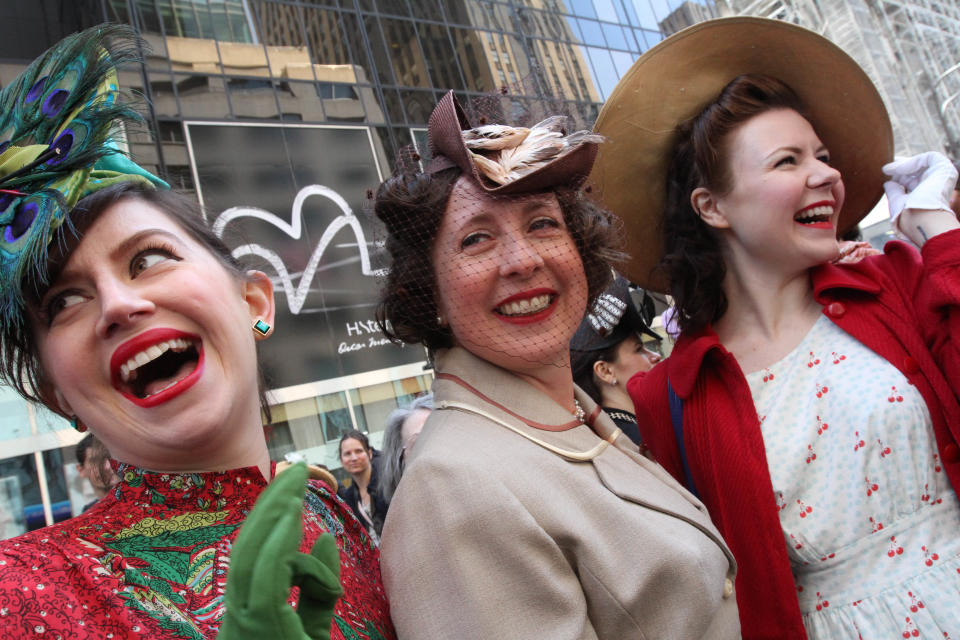 Dressed for the occasion, Ella Morton, right, and others pose for photographs along New York's Fifth Avenue during the Easter Parade, Sunday, April 20, 2014. (AP Photo/Tina Fineberg)