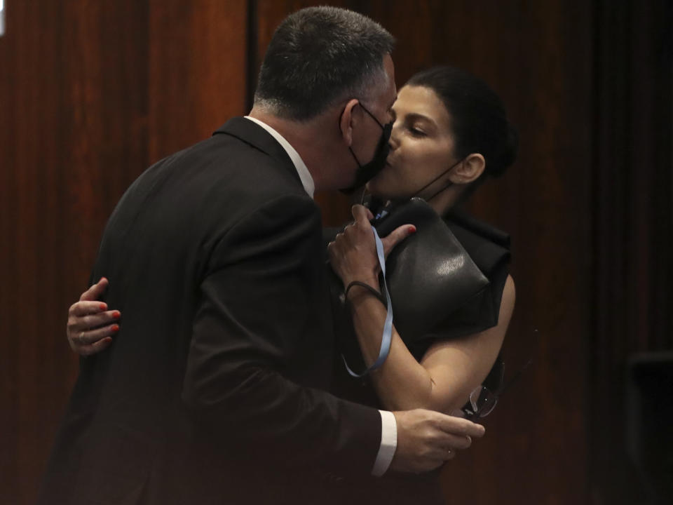 Israeli politician Gideon Saar of the New Hope party kisses his wife Geula Even-Saar during a Knesset session in Jerusalem Sunday, June 13, 2021. Naftali Bennett is expected later Sunday to be sworn in as the country's new prime minister, ending Prime Minister Benjamin Netanyahu's 12-year rule. (AP Photo/Ariel Schalit)