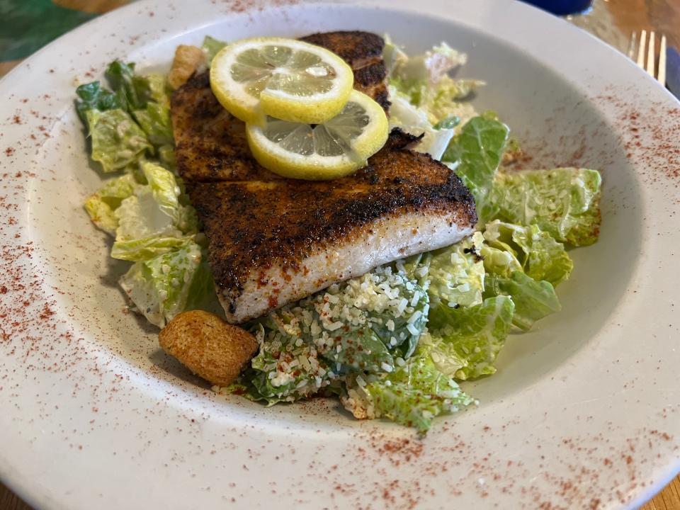 At King Neptune Restaurant in Port Salerno's Manatee Pocket, The blackened mahi over Caesar salad had a pleasing combination of flavors.