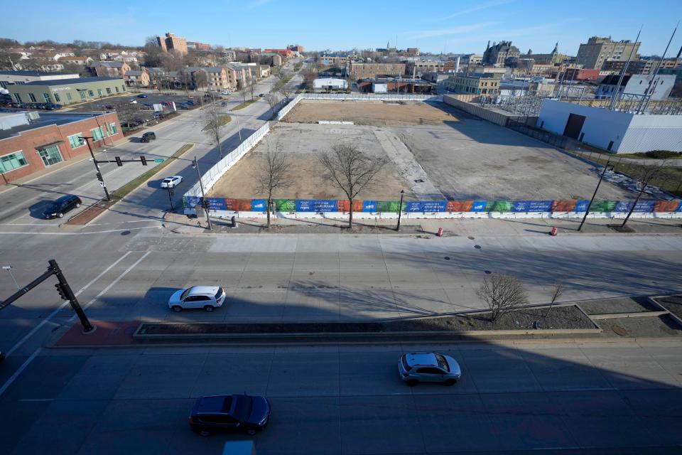 The area of land is fenced off where the relocated Milwaukee Public Museum plans to begin construction along North Sixth Street (left) and West McKinley Avenue in Milwaukee on Wednesday, March 13, 2024. President Joe Biden is expected to highlight a $36.6 million allocation for a project to convert a 2.6-mile section of Sixth Street to a "complete street" during his visit to Milwaukee on Wednesday.