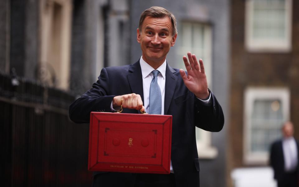 LONDON, ENGLAND - MARCH 15: UK Chancellor Jeremy Hunt leaves Downing Street with the despatch box to present his spring budget to parliament on March 15, 2023 in London, England. Highlights of the 2023 budget are an increase in the tax-free allowance for pensions which the Chancellor hopes will stem the number of people taking retirement, a package of help for swimming pools affected by the increase in energy bills and changes to childcare support for parents on universal credit. (Photo by Dan Kitwood/Getty Images) *** BESTPIX *** - Dan Kitwood/Getty Images Europe