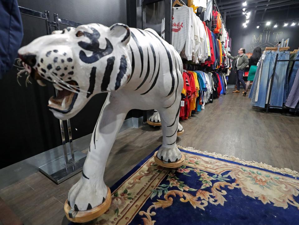 A customer browses the selection of vintage clothing at Modern Traditions Co. inside the Northside Marketplace, Thursday, Nov. 9, 2023, in Akron, Ohio.