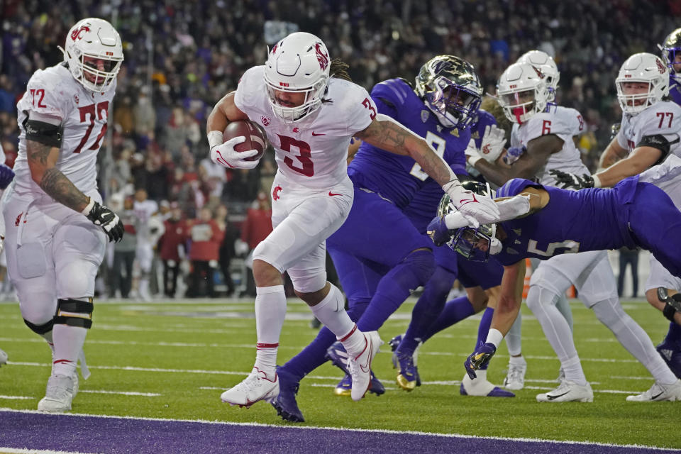 Washington State running back Deon McIntosh (3) scores a touchdown against Washington during the second half of an NCAA college football game, Friday, Nov. 26, 2021, in Seattle. (AP Photo/Ted S. Warren)