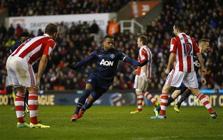 Manchester United's Patrice Evra (C) celebrates scoring during their English League Cup quarter-final soccer match against Stoke City at the Britannia stadium in Stoke-on-Trent, central England, December 18, 2013. REUTERS/Darren Staples