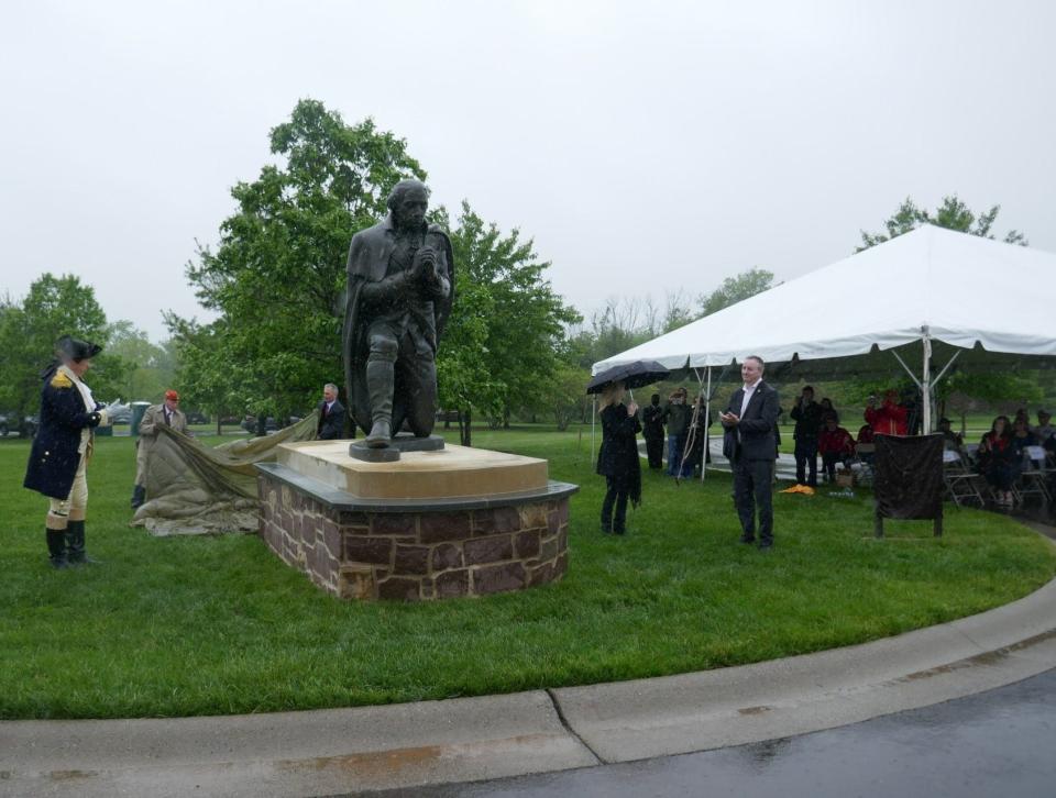 General George Washington re-enactor John Godzieba and Congressman Brian Fitzpatrick watch as the statue of General George Washington is unveiled at the Washington Crossing National Cemetery in Upper Makefield Saturday.