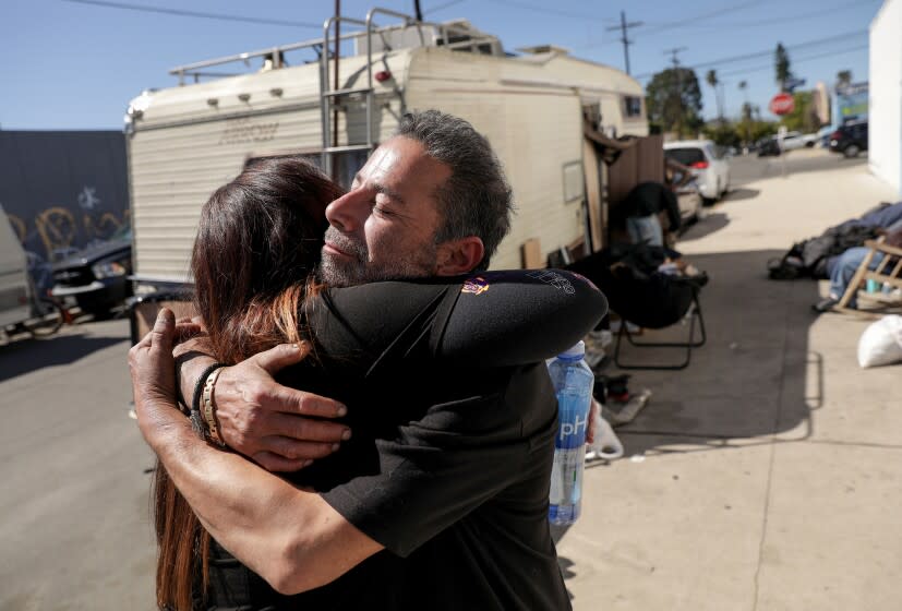 Manny Placeres hugs registered nurse Linda Leimer, with an L.A. County Department of Health Services medical team