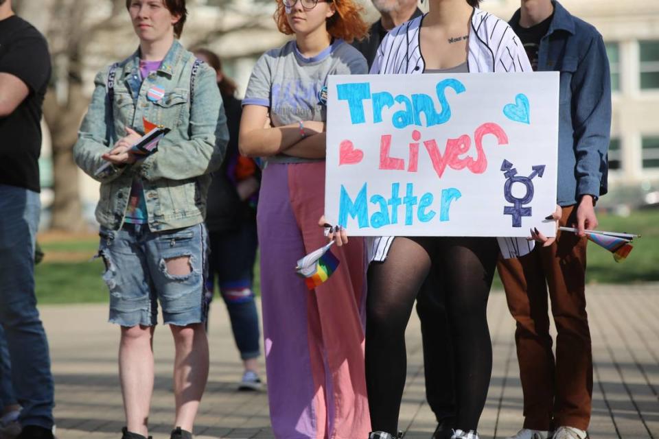 A demonstrator listens to speakers at a rally held in Topeka in support of transgender youth in Kansas. It comes amid a raft of anti-transgender legislation in the Sunflower State.