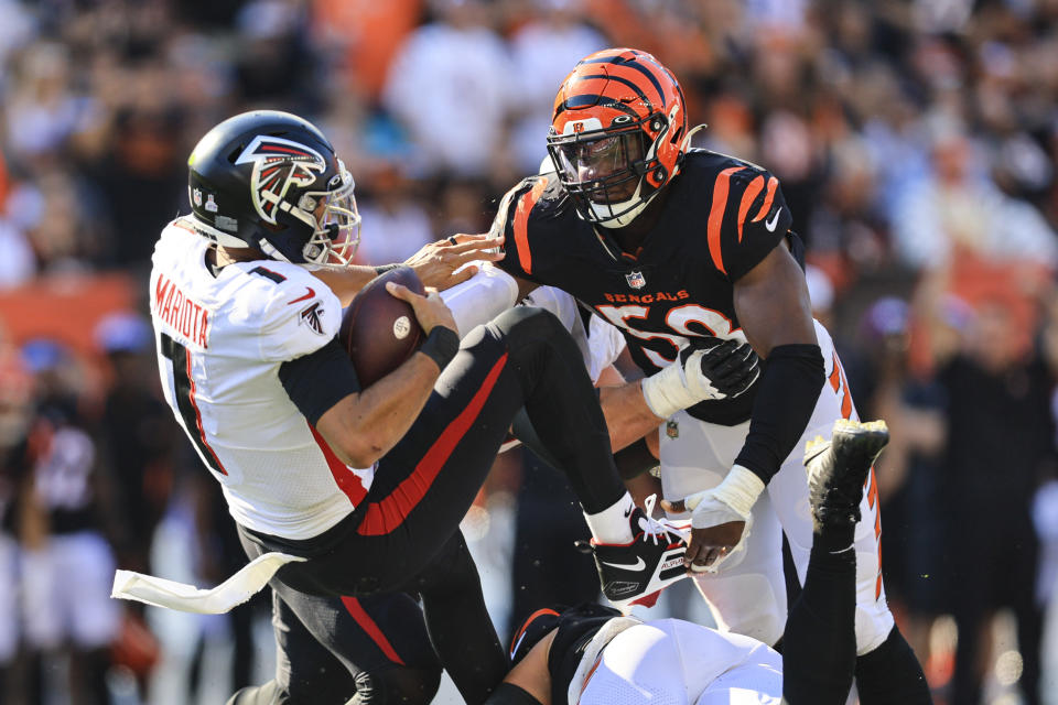 Atlanta Falcons quarterback Marcus Mariota (1) is sacked by Cincinnati Bengals defensive end Joseph Ossai (58) in the second half of an NFL football game in Cincinnati, Fla., Sunday, Oct. 23, 2022. (AP Photo/Aaron Doster)