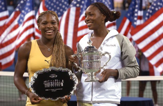 <p>Matthew Stockman/Allsport</p> Venus and Serena Williams at the 2001 U.S. Open