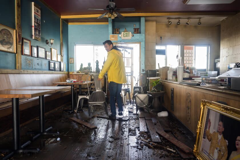 Dominic King, owner of My Thai Beach, surveys storm damage that destroyed his restaurant in Capitola, Calif., Thursday, Jan. 5, 2023. Damaging hurricane-force winds, surging surf and heavy rains from a powerful "atmospheric river" pounded California on Thursday, knocking out power to tens of thousands, causing flooding, and contributing to the deaths of at least two people, including a child whose home was hit by a falling tree. (AP Photo/Nic Coury)