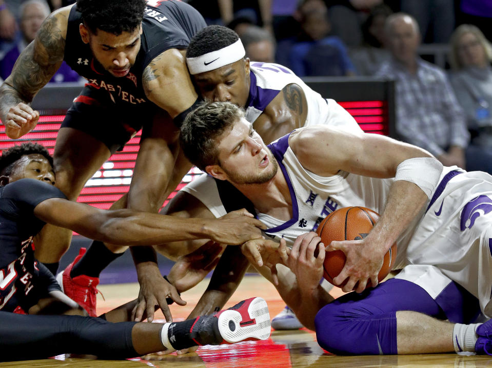 Texas Tech's Jarrett Culver, left, tries to steal the ball from Kansas State's Dean Wade during the second half of an NCAA college basketball game Tuesday, Jan. 22, 2019, in Manhattan, Kan. Kansas State won 58-45. (AP Photo/Charlie Riedel)
