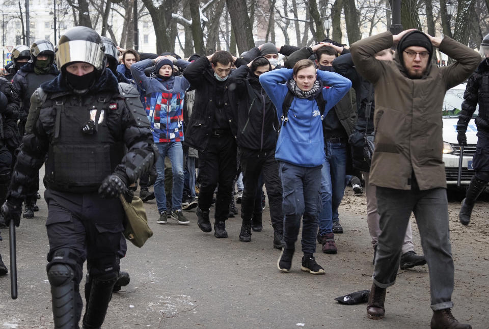 FILE - Detained protesters are escorted by police during a protest in St. Petersburg, Russia, on Sunday, Jan. 31, 2021, over the jailing of opposition leader Alexei Navalny. (AP Photo, File)