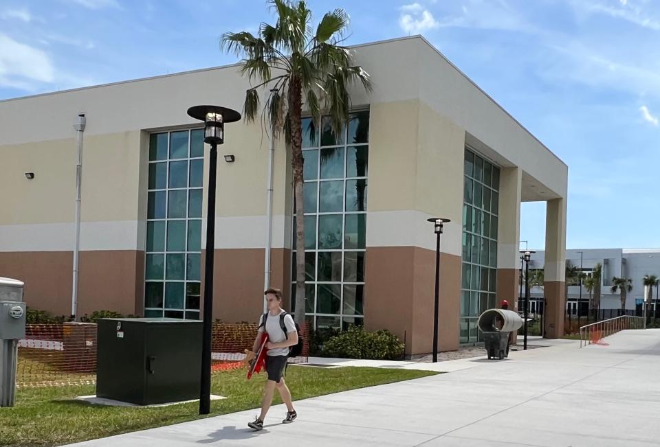 An Embry-Riddle Aeronautical University student walks past the future Boeing Center for Aviation & Aerospace Safety at ERAU's Daytona Beach on Friday, April 7, 2023.