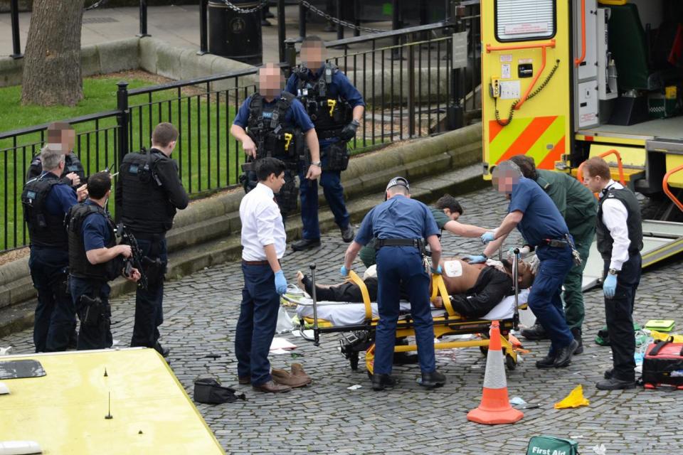 Killer Khalid Masood being treated after he mowed down pedestrians and killed PC Keith Palmer (Stefan Rousseau/PA )