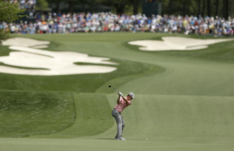 Justin Rose, of England, prepares to hit his approach shot to the fifth green during the first round of the Wells Fargo Championship golf tournament in Charlotte, N.C., Thursday, May 1, 2014. (AP Photo/Chuck Burton)
