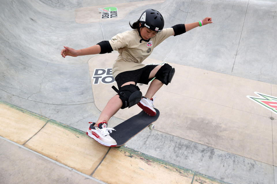Misugu Okamoto grinding her skateboard on the edge of a skate park pool