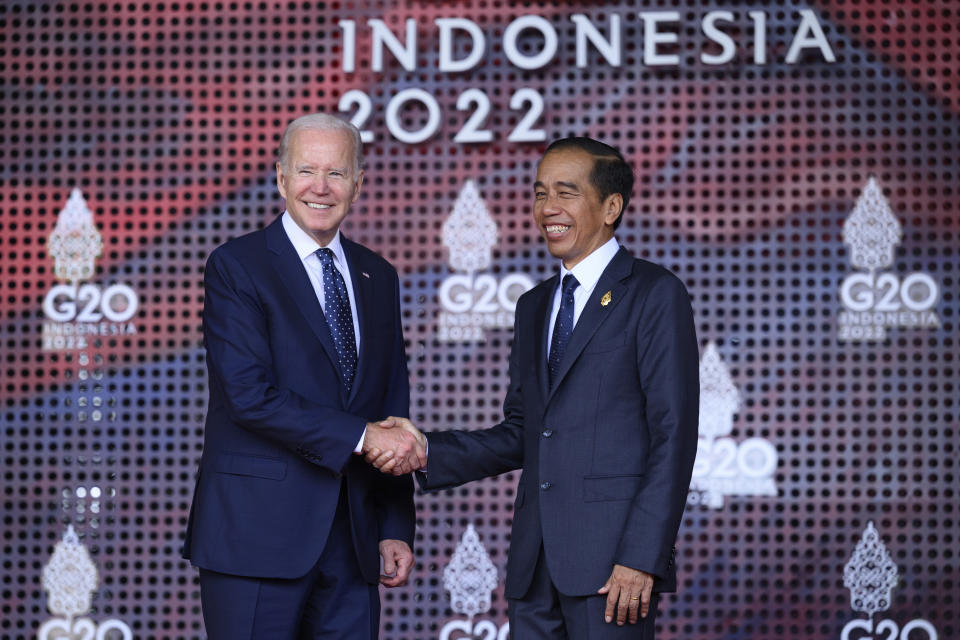 U.S. President Joe Biden, left, is greeted by the Indonesian President Joko Widodo at the beginning of the G20 Summit, Tuesday, Nov. 15, 2022, in Nusa Dua, Bali, Indonesia. (Leon Neal/Pool Photo via AP)