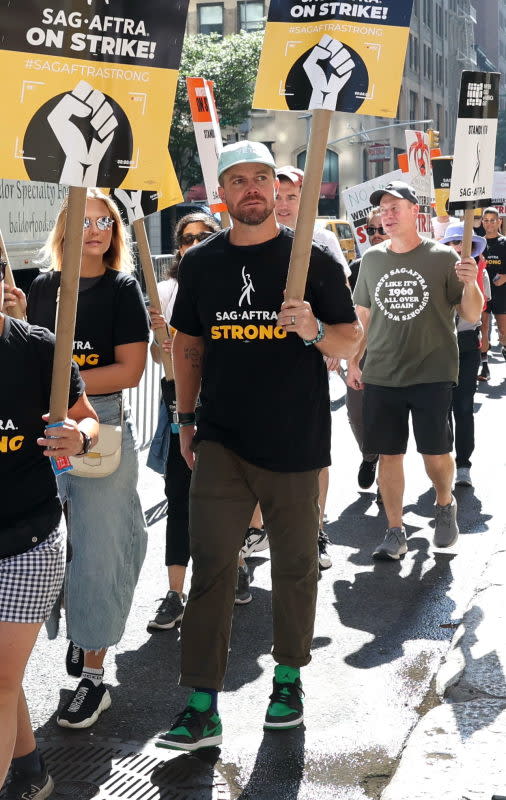 Cassandra Jade and Stephen Amell are seen on the SAG-AFTRA picket line in New York City on Aug. 11, 2023.<p>Jose Perez/Bauer-Griffin/Getty Images</p>