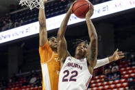 Auburn guard Allen Flanigan (22) is fouled by Tennessee guard Keon Johnson (45) as he puts up a shot during the first half of an NCAA basketball game Saturday, Feb. 27, 2021, in Auburn, Ala. (AP Photo/Butch Dill)