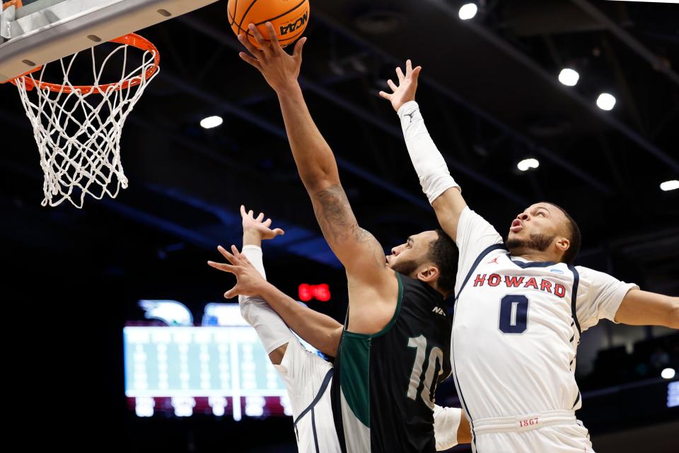 Mar 19, 2024; Dayton, OH, USA; Wagner Seahawks guard Tahron Allen (10) shoots the ball defended by Howard Bison guard Marcus Dockery (0) in the first half at UD Arena. Mandatory Credit: Rick Osentoski-USA TODAY Sports