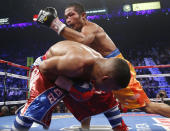 Michael Farenas, from the Philippines, top, misses with a left against Yuriorkis Gamboa, from Miami, Fla., during their WBA interim super featherweight title fight Saturday, Dec. 8, 2012, in Las Vegas. (AP Photo/Eric Jamison)