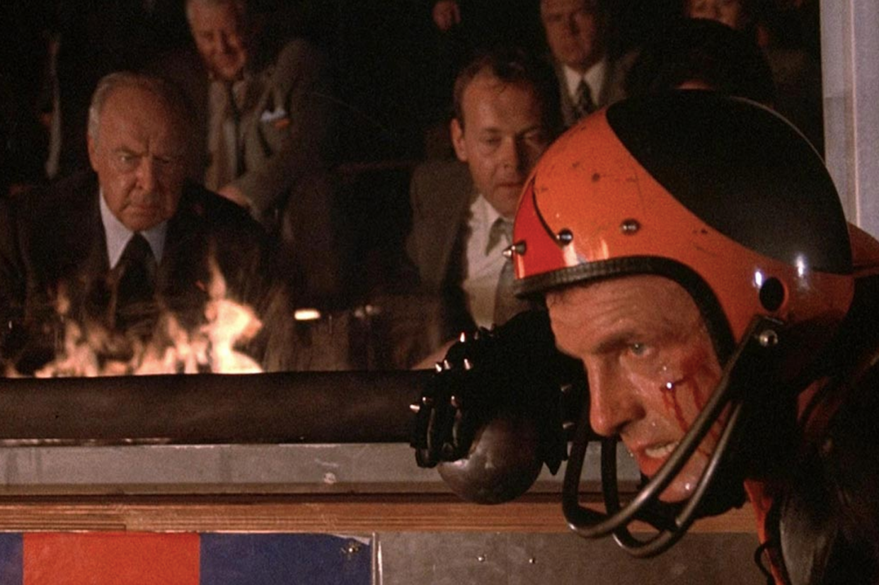 Jonathan E., played by James Caan, competes as the owners watch from the stands. <a href="https://silverscreenings.files.wordpress.com/2023/04/rollerball-1975.jpg" rel="nofollow noopener" target="_blank" data-ylk="slk:MGM;elm:context_link;itc:0;sec:content-canvas" class="link ">MGM</a>