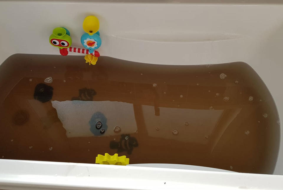 Dirty water seen in a bathtub.