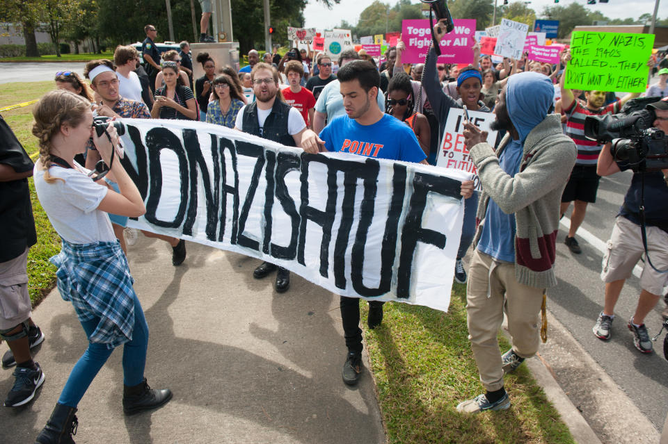 People march down 34th street to the entrance of the University of Florida.&nbsp;