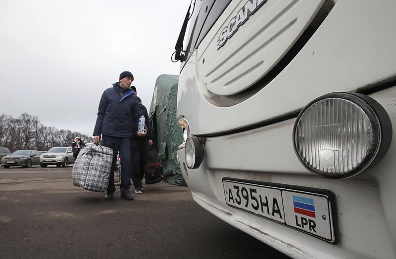 Men board a bus during prisoner of war exchange between Ukraine and the separatist republics in Donetsk region