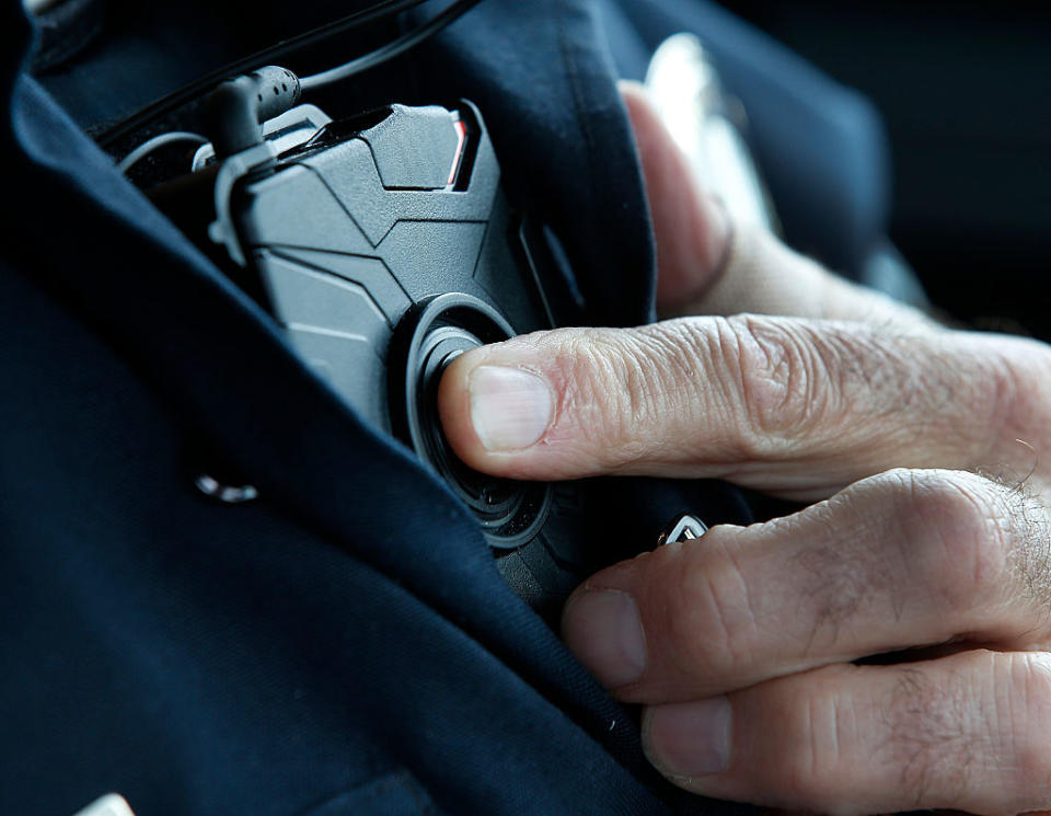 A patrol officer in West Valley City, Utah, presses a button to start a new body camera recording in 2015 before he takes a theft report. (Photo by George Frey/Getty Images)